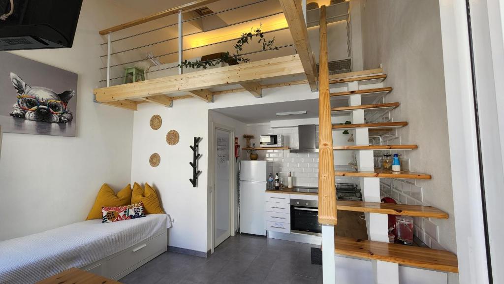a small apartment with a staircase and a kitchen at Tiny House Faro in Faro