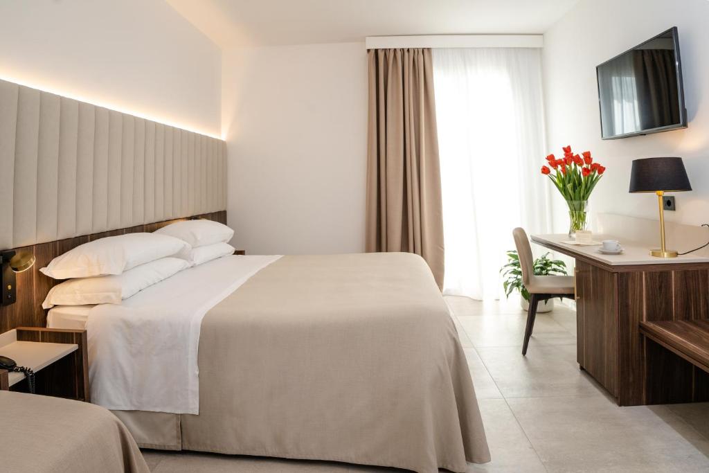 Postel nebo postele na pokoji v ubytování Hotel Falli