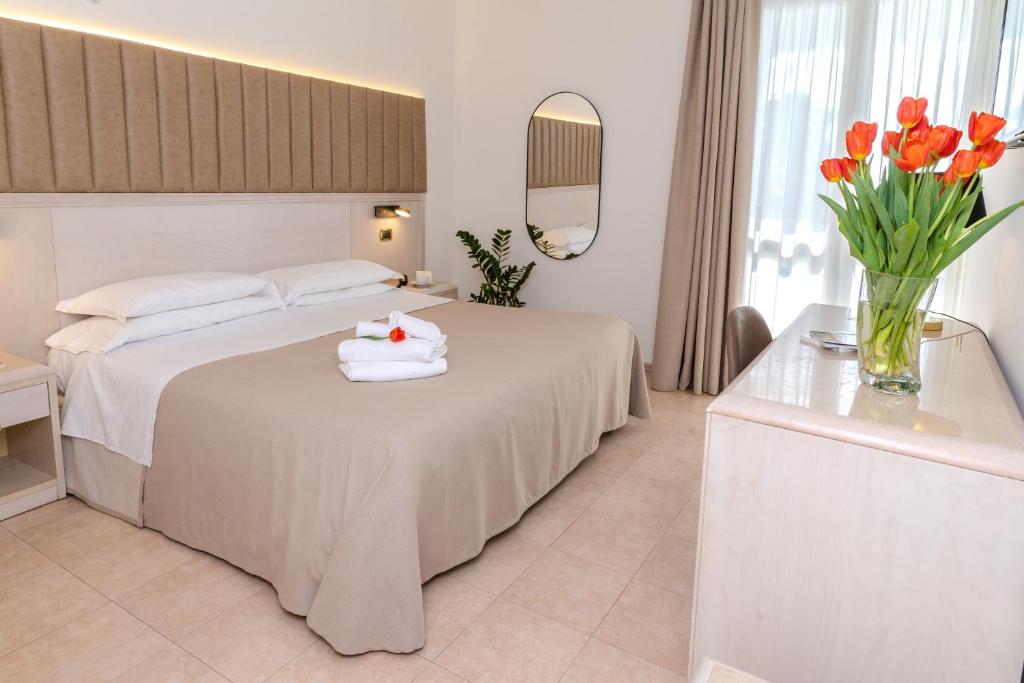 Postel nebo postele na pokoji v ubytování Hotel Falli