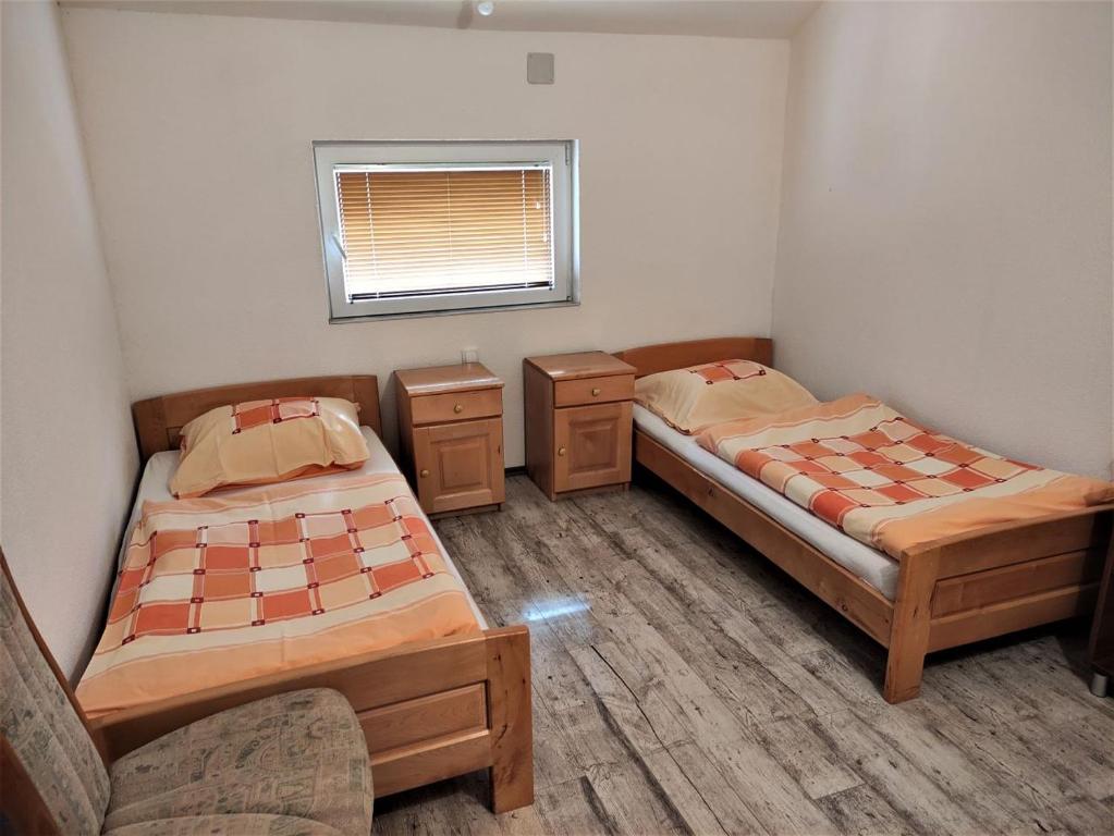 a room with two beds and a couch in it at Apatments Radoja - Pliva in Šipovo