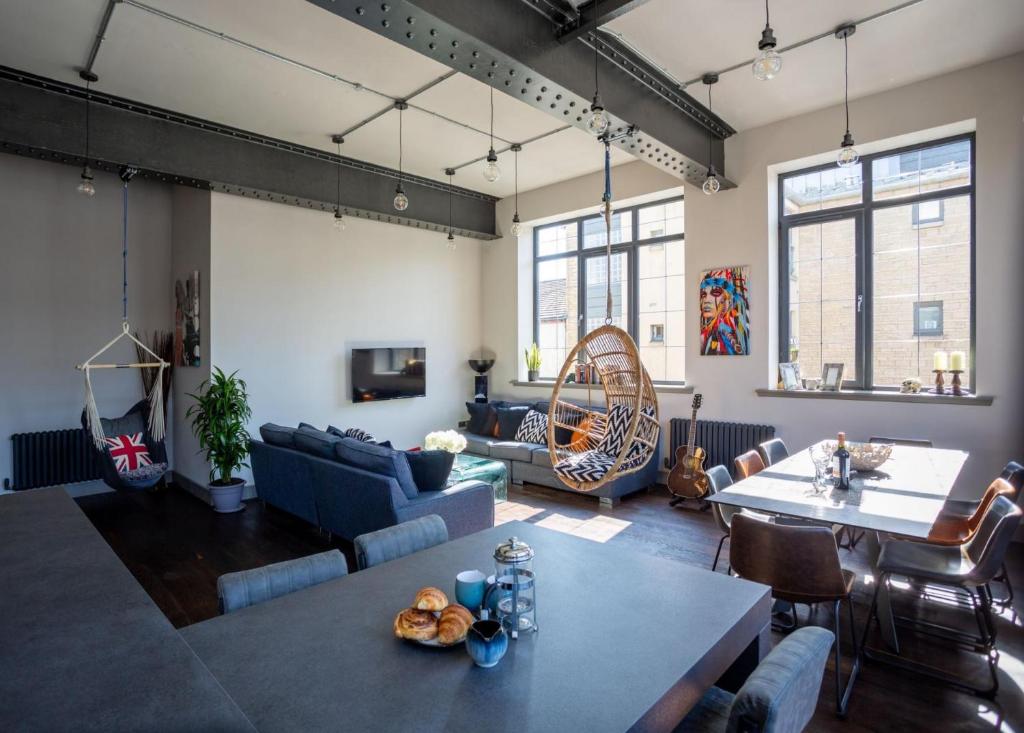 a living room with a couch and a table at Luxury Manhattan loft-style apartment near Edinburgh city centre in Edinburgh