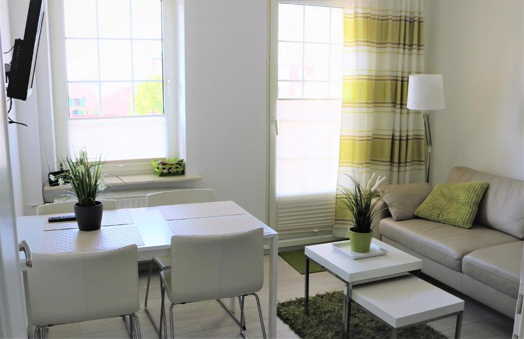 a living room with a table and a couch at Nordsee 03 in Cuxhaven