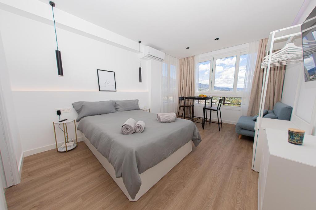 a bedroom with a bed with two towels on it at Modern Apartment With Stunning Views in Marbella