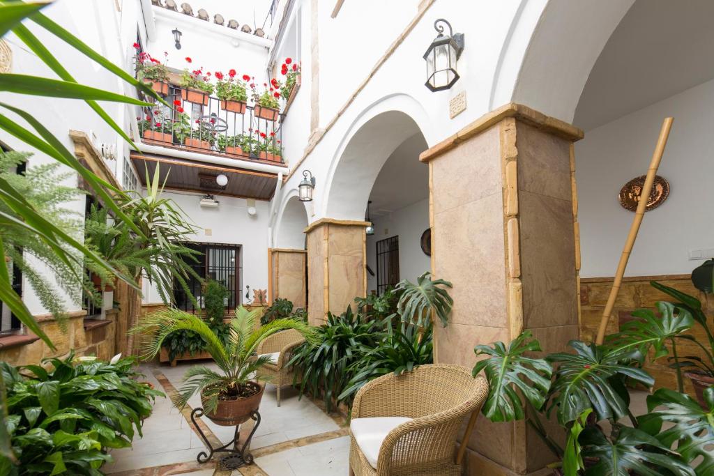 an indoor courtyard with plants in a building at Casa Turística Patio Cordobés - Parking privado en la Judería in Córdoba