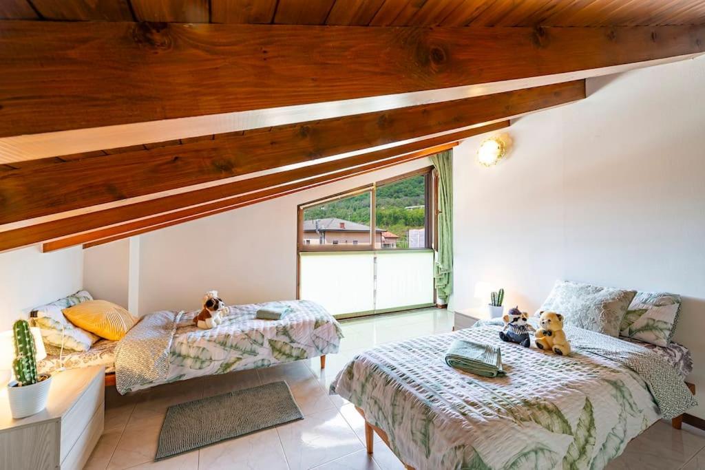 Łóżko lub łóżka w pokoju w obiekcie Tresa Bay House - Lugano Lake