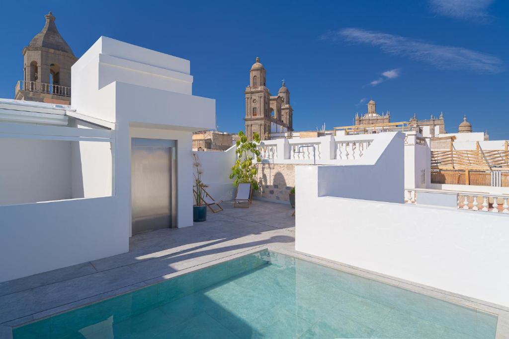 a villa with a swimming pool and a building at Boutique Hotel Cordial La Niña de Vegueta in Las Palmas de Gran Canaria