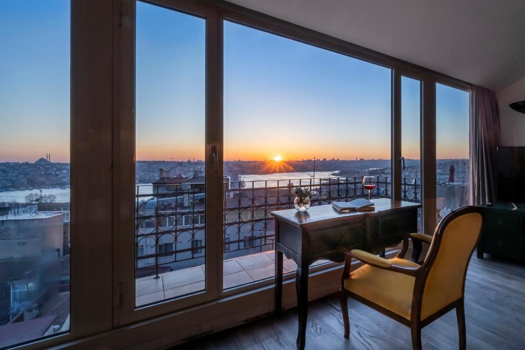 a desk and chair in a room with a large window at Ansen Hotel and Suites in Istanbul