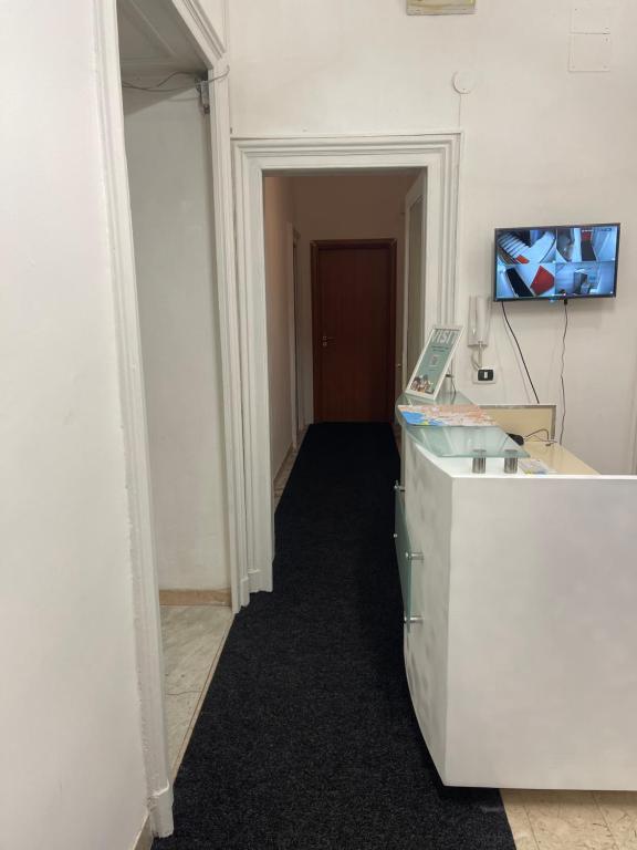 an office with a white desk and a hallway at A I R Garibaldi Apartment in Naples