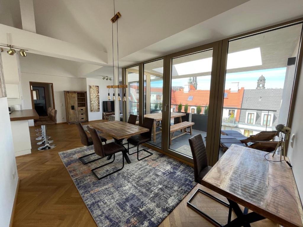 a living room with a table and chairs and a dining room at Modernes Apartment An der Frauenkirche II in Dresden