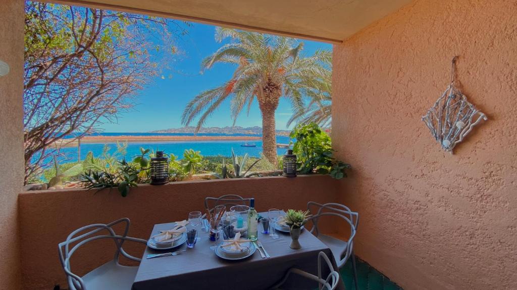 a table in a restaurant with a view of the ocean at Grecalotto Apartment in La Maddalena