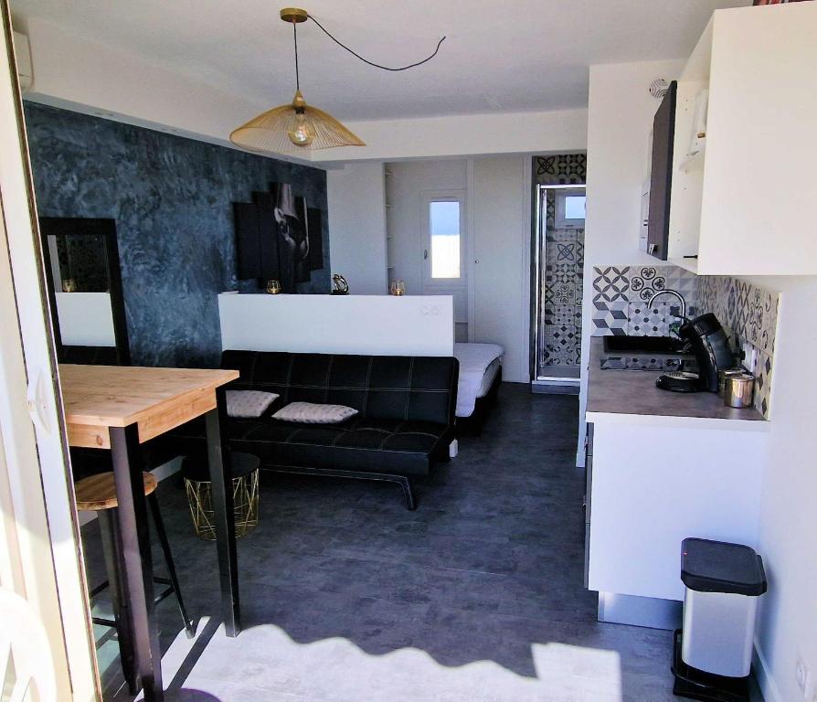 a living room with a couch and a table at Cyllène Port Nature 5 in Cap d'Agde