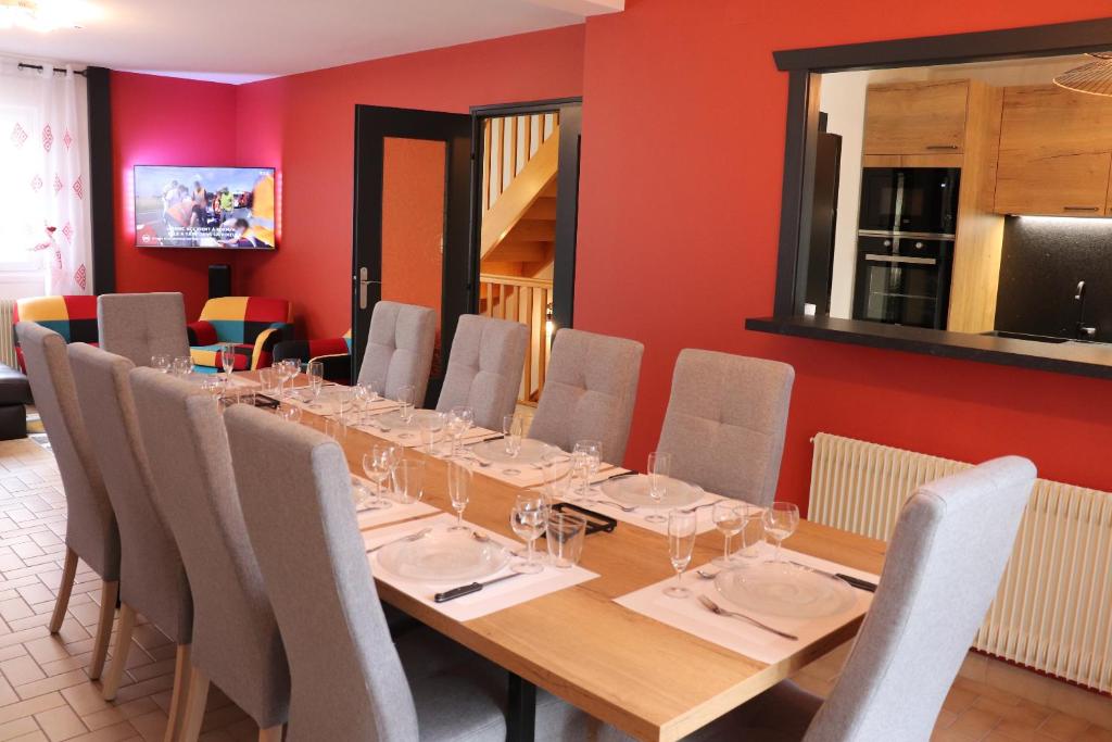 une salle à manger avec une longue table et des chaises dans l'établissement Gîte les Pervenches avec Sauna, à Gérardmer