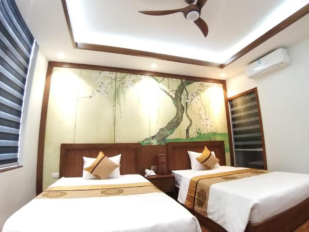 Postel nebo postele na pokoji v ubytování Samatha Hotel Bai Chay, Ha Long