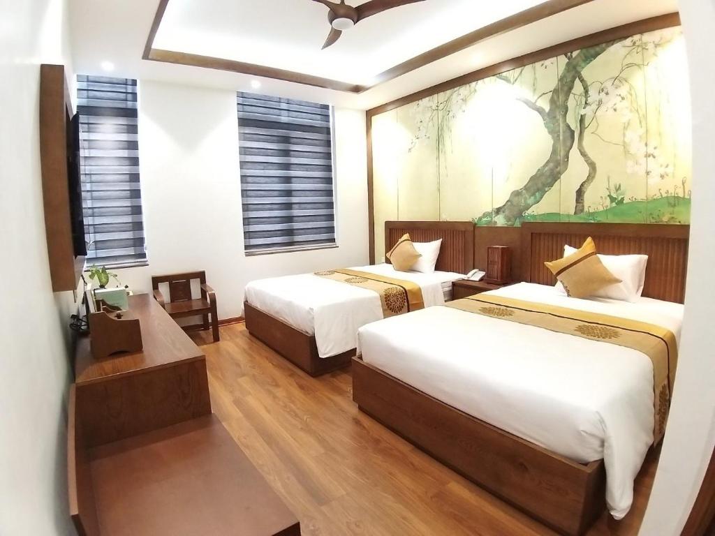 Postel nebo postele na pokoji v ubytování Samatha Hotel Bai Chay, Ha Long