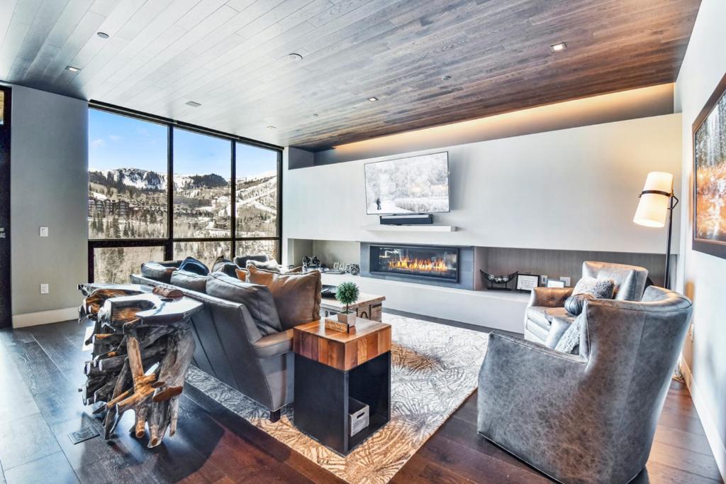 a living room with couches and a fireplace at One Empire #303 in Park City