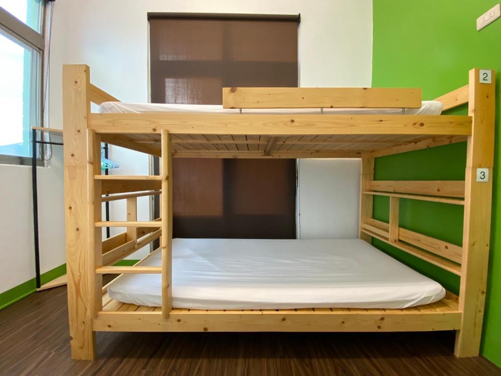 Postel nebo postele na pokoji v ubytování 澎湖北吉光背包客民宿 Bayhouse Hostel Penghu