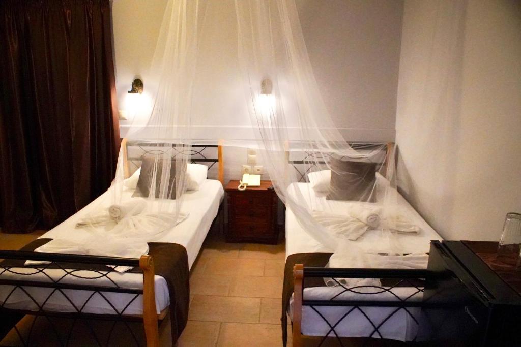 Postel nebo postele na pokoji v ubytování Hotel Notara