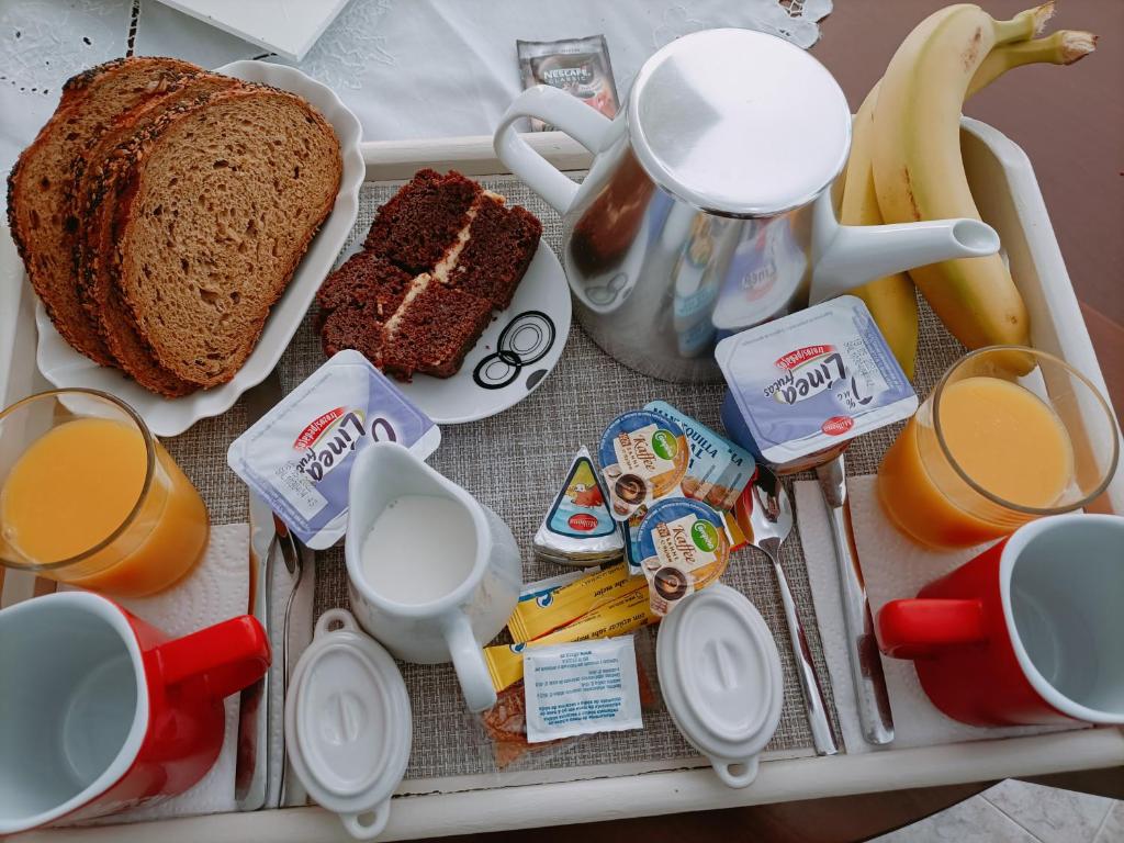 a tray with bread and orange juice and breakfast food at Cottage in Ciudad Quesada in Ciudad Quesada