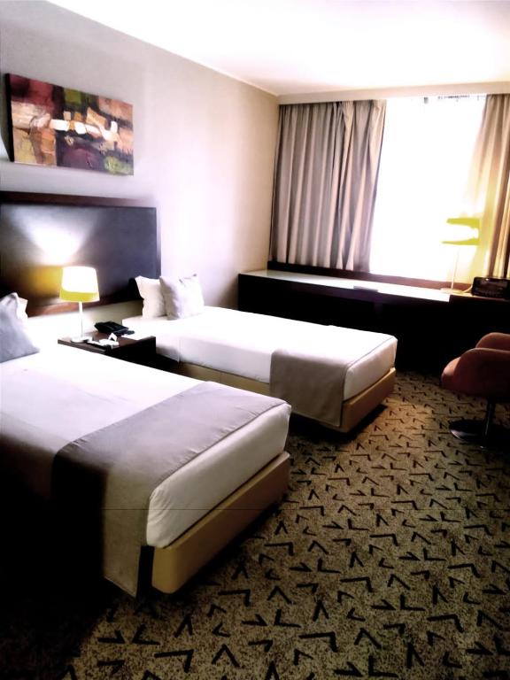 Postel nebo postele na pokoji v ubytování Skyna Hotel Luanda