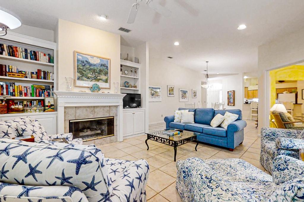 a living room with a blue couch and a fireplace at 4954 Summer Beach Blvd in Fernandina Beach