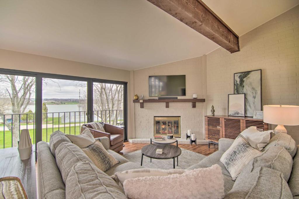 a living room with a couch and a fireplace at Cozy Lake Geneva Retreat with Year-Round Views! in Lake Geneva