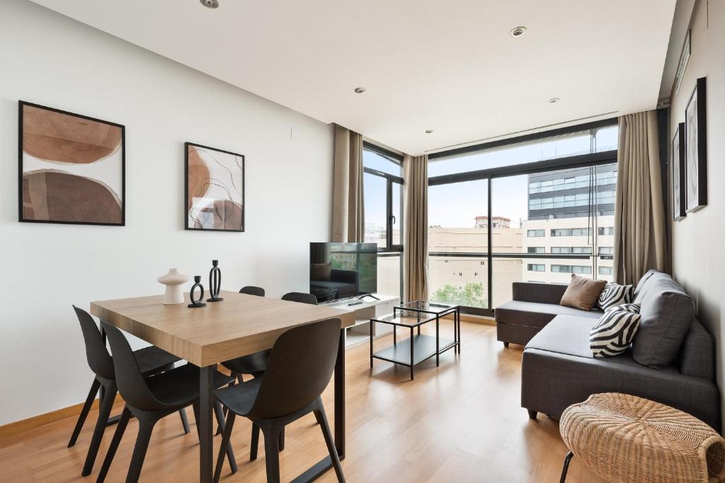 a living room with a table and a couch at chicStays Apartment Ciutadella Park in Barcelona