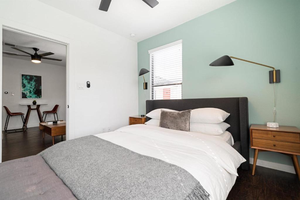 a bedroom with a bed and a table with chairs at Abode Houston - Montrose Downtown in Houston
