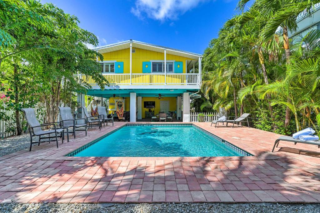 a house with a swimming pool in front of a house at Key Largo Paradise with Heated Pool and Hot Tub! in Key Largo