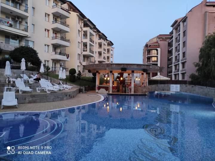 a large swimming pool in front of a building at Sunny Beach Hills Apartment - Private in Sunny Beach