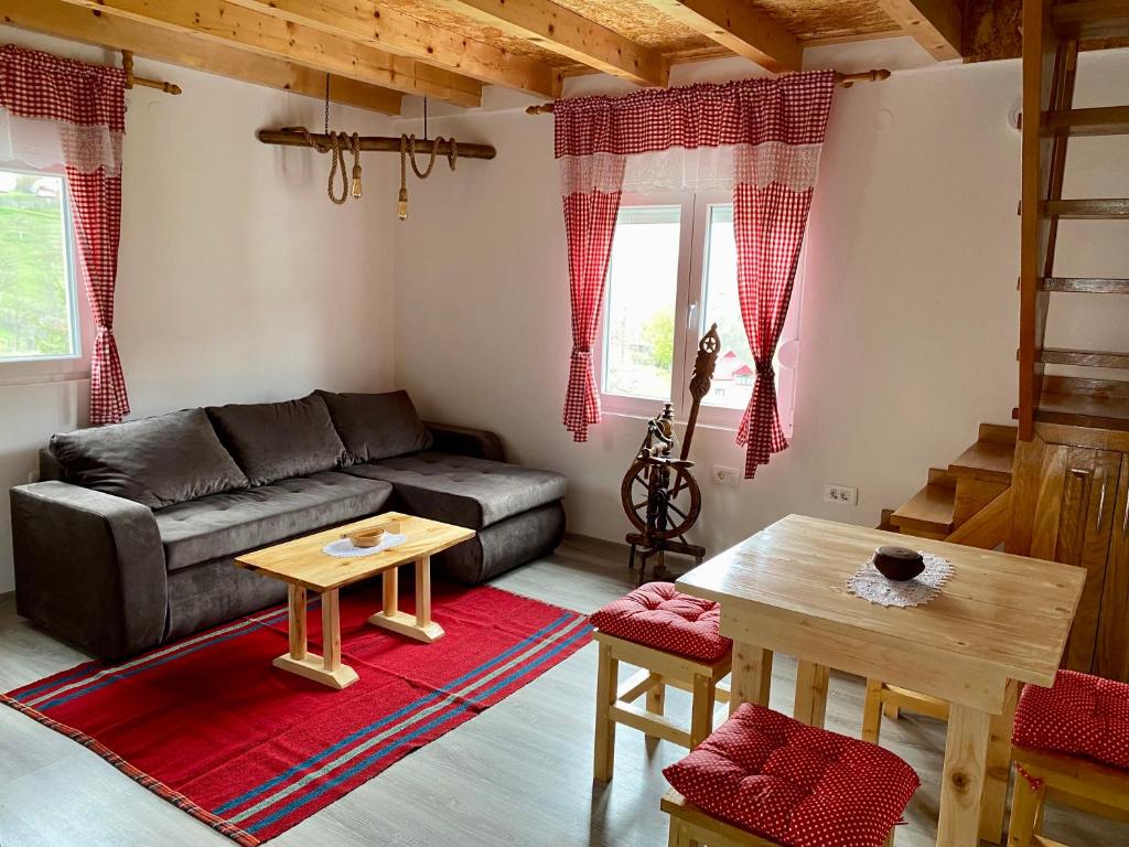 a living room with a couch and a table at Crossroads Preseka in Plužine