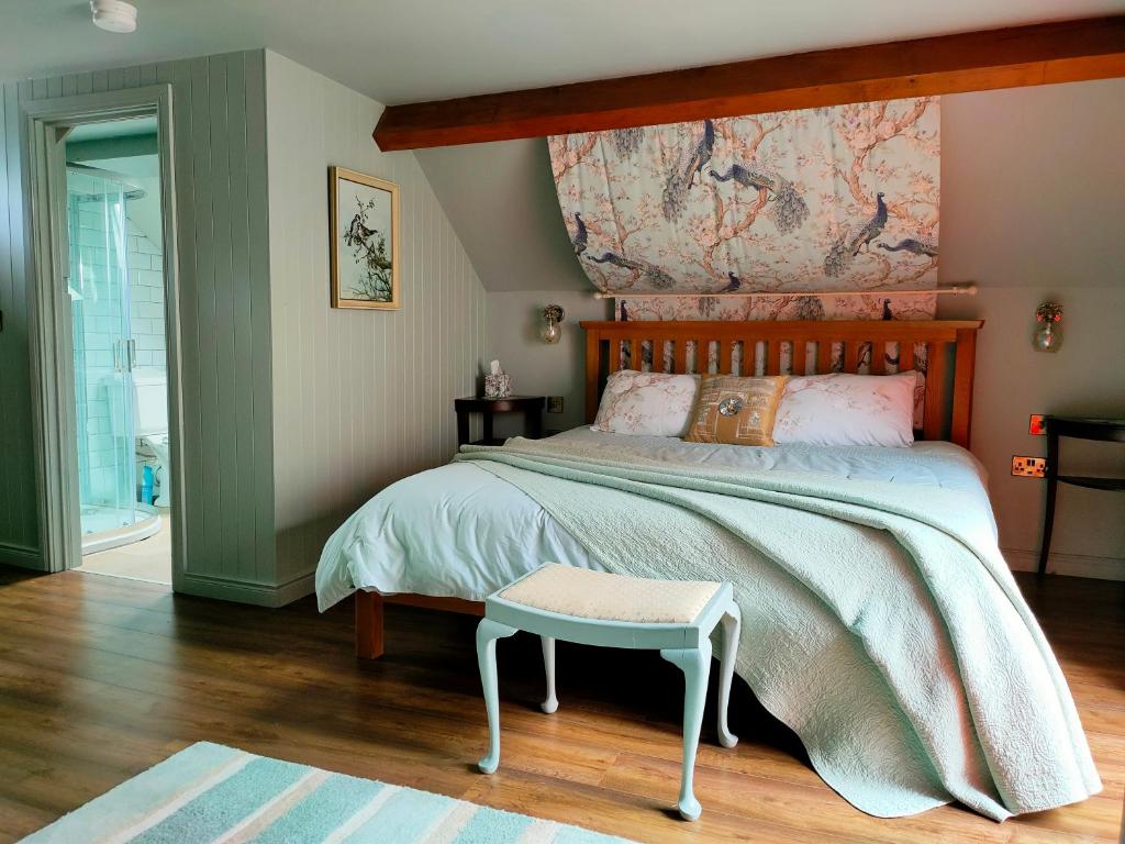 a bedroom with a large bed with a map on the wall at Horseshoe Cottage Greyabbey in Greyabbey