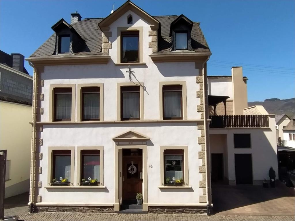 Casa blanca con puerta y ventanas en Ferienhaus Treis en Neef