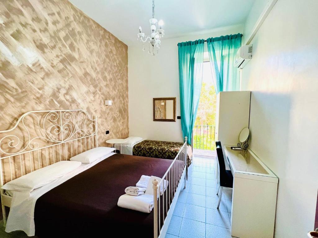 Postel nebo postele na pokoji v ubytování Hotel Pisa