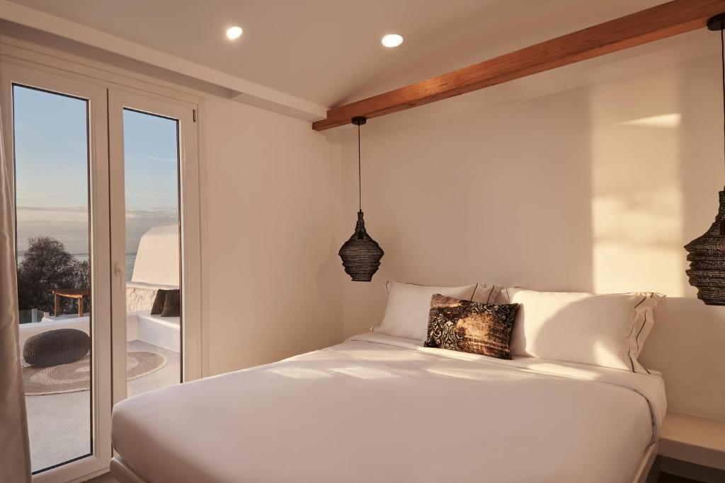 Posteľ alebo postele v izbe v ubytovaní Hill Club Naxos