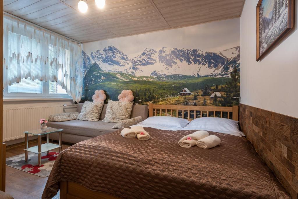 a bedroom with a bed with a mountain mural on the wall at Byt Staré koliesko, Jasná, Demänovská Dolina in Belá