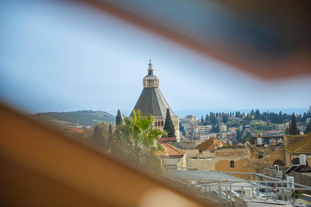 a view of a building with a clock tower at Michel House in Nazareth