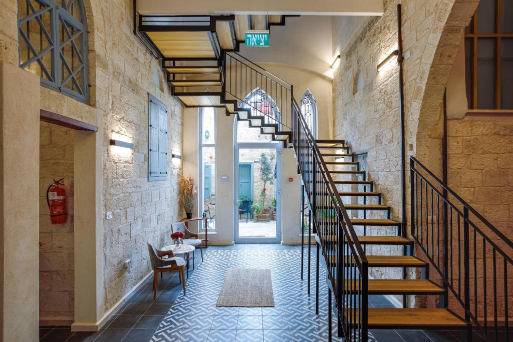 a hallway with a spiral staircase in a building at Michel House in Nazareth