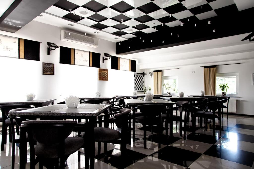 a restaurant with tables and chairs in a room at MotelChuk in Ivano-Frankivsk