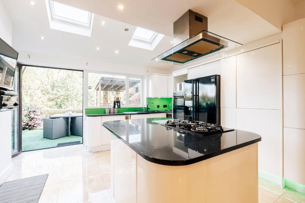 a kitchen with a black counter top in a room at Luxury Unique Townhouse with Hottub & Pizza Oven in Bolton