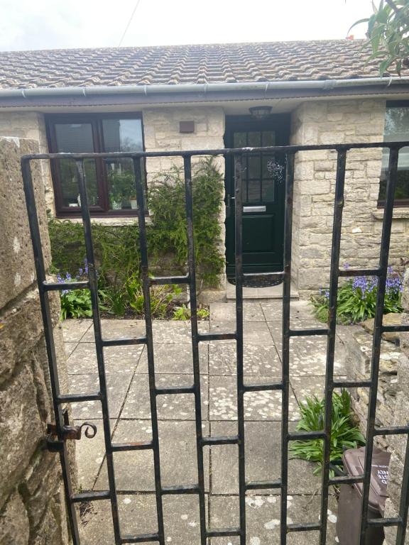 a gate in front of a house with a door at Quality Court in Langton Matravers