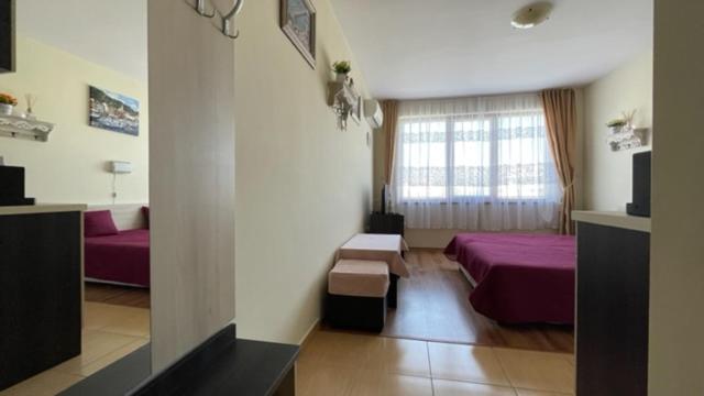 A bed or beds in a room at SUMMER BREEZE 406 Studio Sunny Beach
