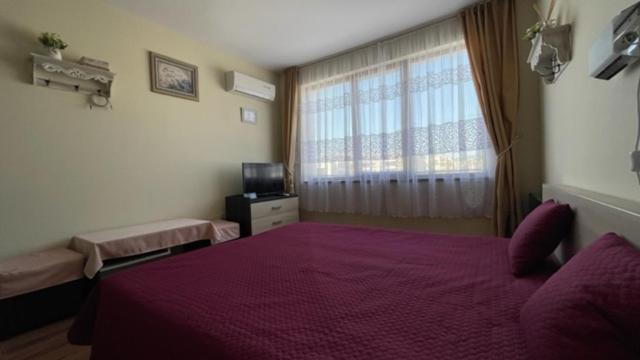 A bed or beds in a room at SUMMER BREEZE 406 Studio Sunny Beach