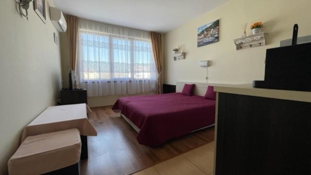 A bed or beds in a room at SUMMER BREEZE 406 Studio Sunny Beach