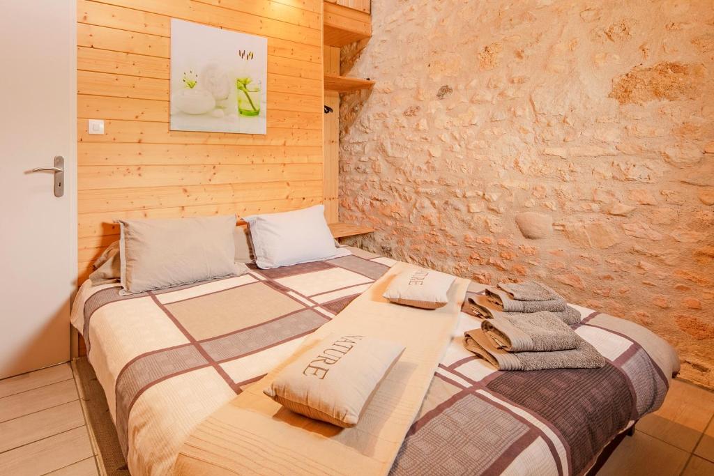 a bedroom with a bed with towels on it at The Wild Seeds in Chauvigny