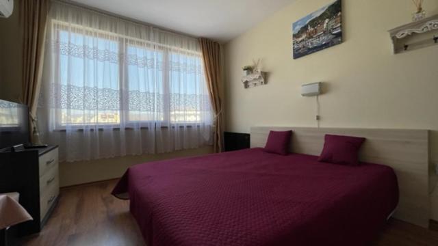 A bed or beds in a room at SUMMER BREEZE 406 Studio Sunny Beach
