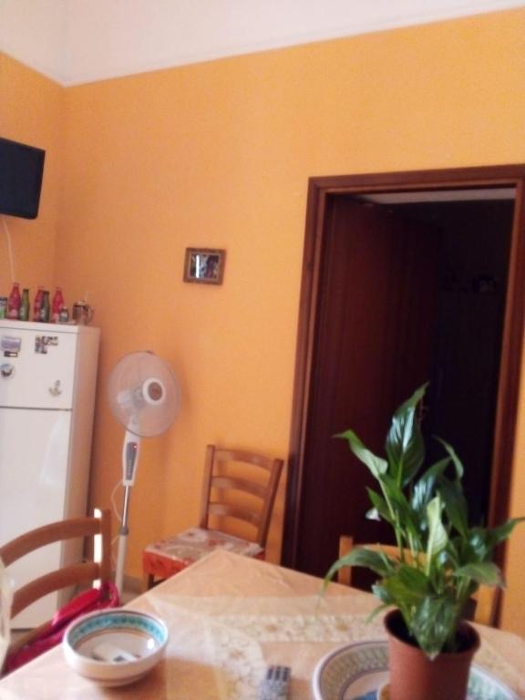 a kitchen with a table with a potted plant on it at Apartment A&M in Marsala