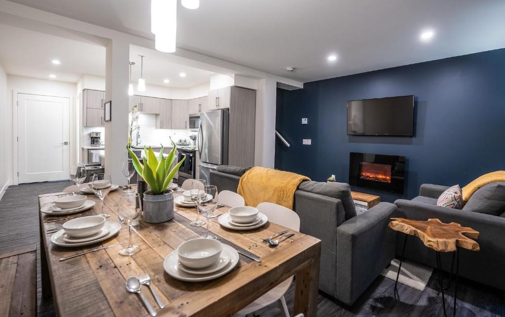a dining room and living room with a table and couch at Alpine Escape by Revelstoke Vacations in Revelstoke