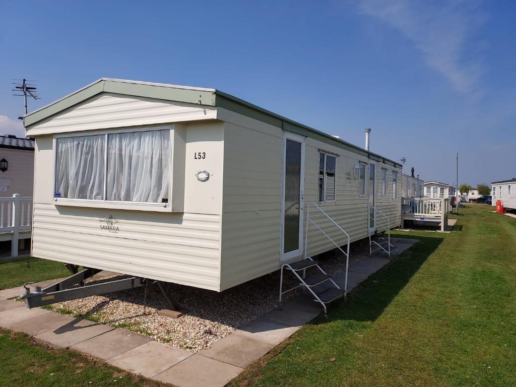 a large white mobile home in a yard at 8 Berth The Chase Ingoldmells Sahara Super in Ingoldmells