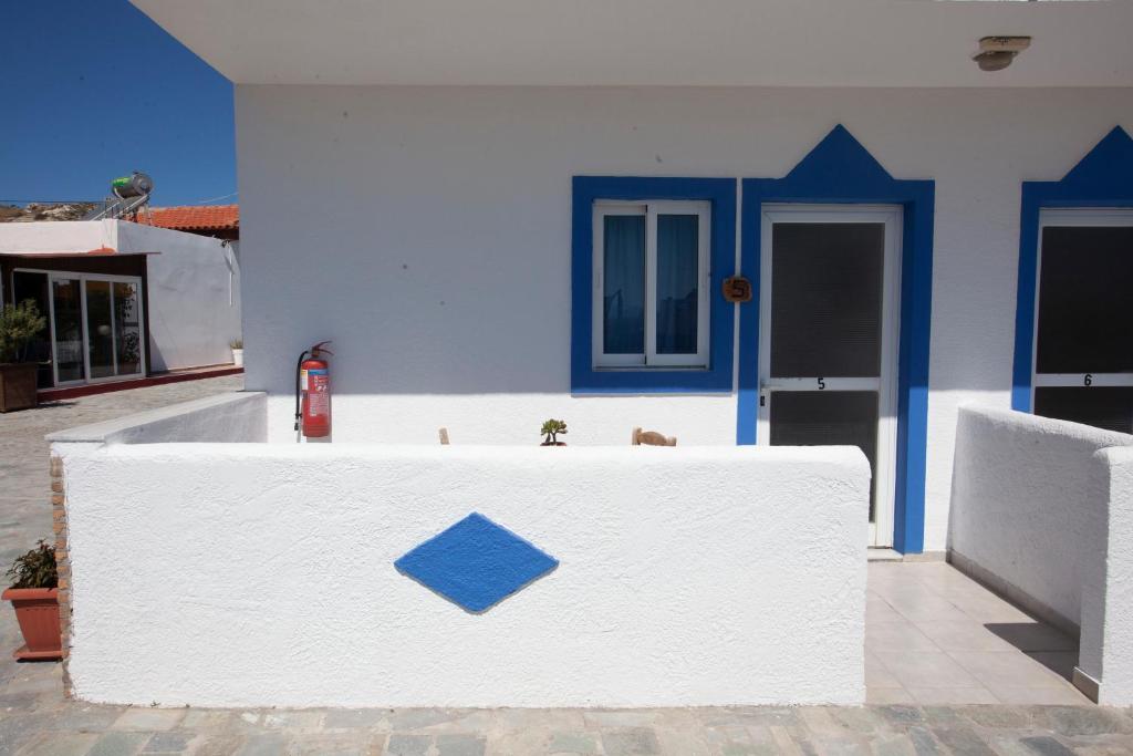 a white building with a fire hydrant in front of it at Villa Bel Passo Apartments in Kefalos