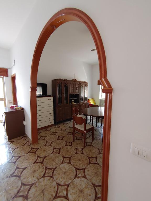 łuk w kuchni ze stołem i krzesłami w obiekcie Ferienhaus am Ionischem Meer w mieście Marina di Lizzano